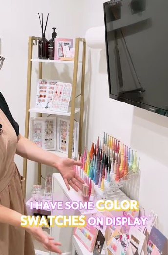 Tina showing colorful nail swatches inside her private Silicon Valley nail studio