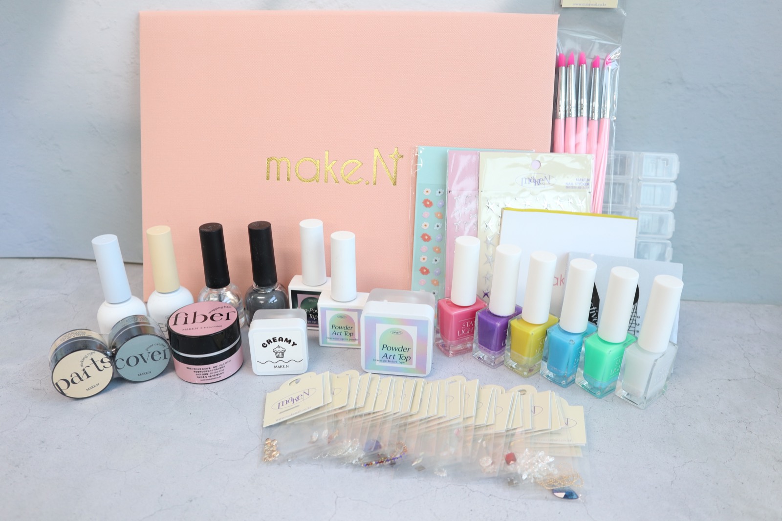 Make.N seminar supplies including professional gels, charms, textbook, and certification materials